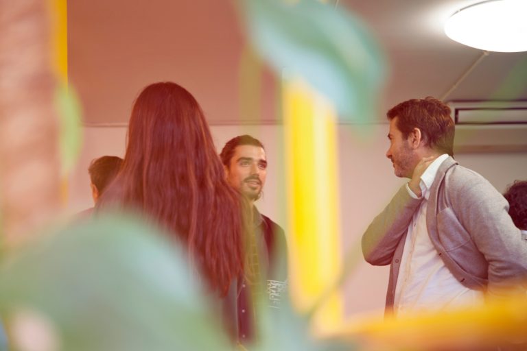Colleagues talking at event